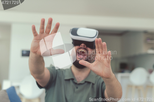 Image of man with beard trying vr glasses