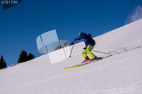 Image of Skier having fun while running downhill