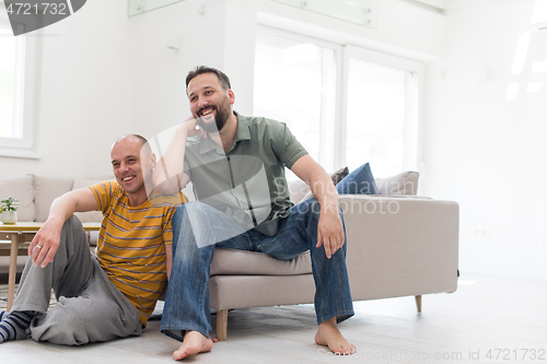 Image of Portrait of male gay couple with adopted childre