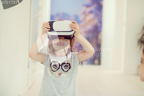 Image of little girl at home wearing vr glasses