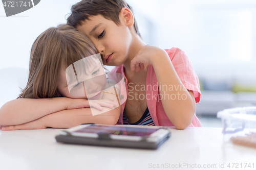 Image of cute little brother and sister having fun at home