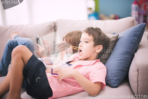 Image of cute little brother and sister having fun at home