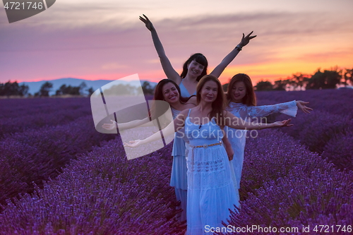 Image of group of famales have fun in lavender flower field