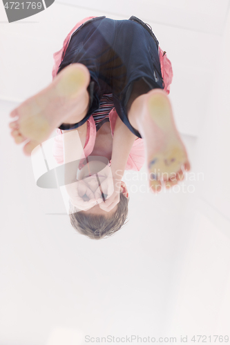 Image of little boy standing on transparent glass floor