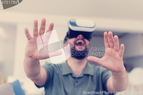 Image of man with beard trying vr glasses