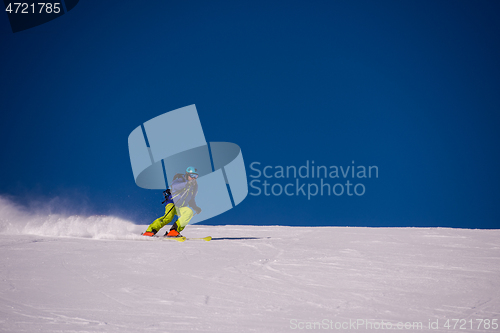 Image of Skier having fun while running downhill