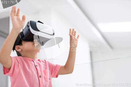 Image of kid at home playing games on vr glasses