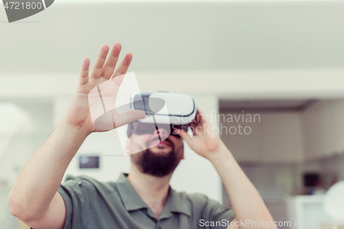 Image of man with beard trying vr glasses