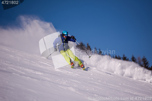 Image of Skier having fun while running downhill