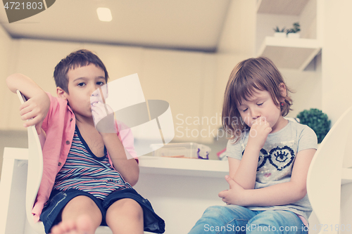 Image of cute little brother and sister at home