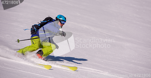 Image of Skier having fun while running downhill