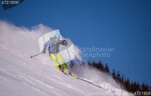 Image of Skier having fun while running downhill