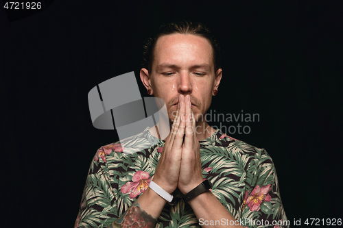 Image of Close up portrait of young man isolated on black studio background