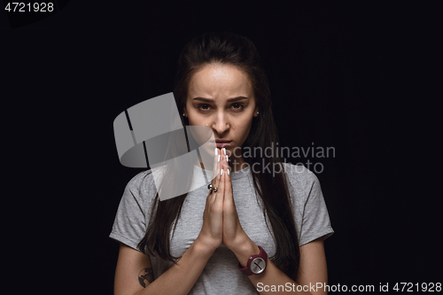 Image of Close up portrait of young woman isolated on black studio background