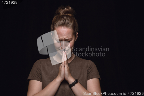 Image of Close up portrait of young woman isolated on black studio background