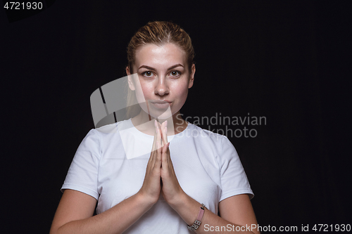 Image of Close up portrait of young woman isolated on black studio background