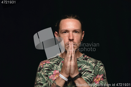 Image of Close up portrait of young man isolated on black studio background