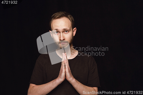 Image of Close up portrait of young man isolated on black studio background