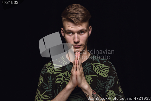 Image of Close up portrait of young man isolated on black studio background