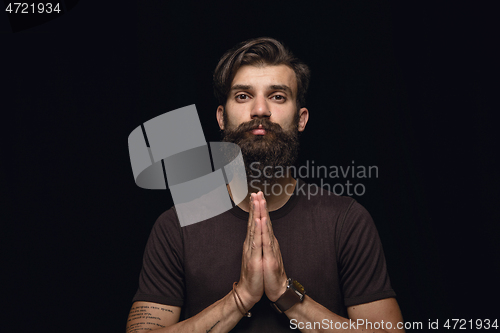 Image of Close up portrait of young man isolated on black studio background