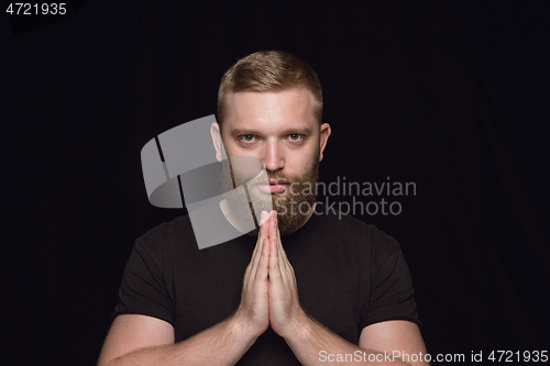 Image of Close up portrait of young man isolated on black studio background