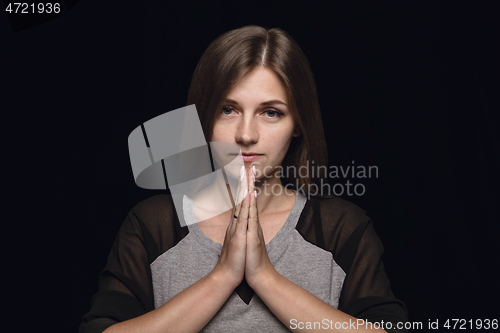 Image of Close up portrait of young woman isolated on black studio background