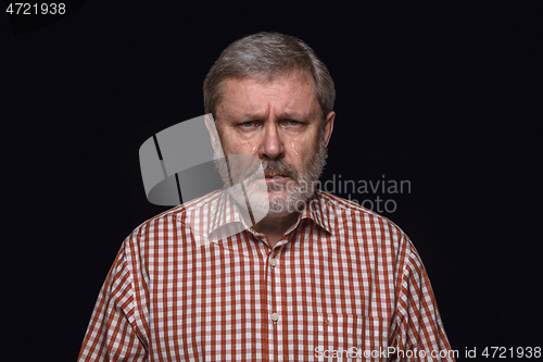 Image of Close up portrait of senior man isolated on black studio background