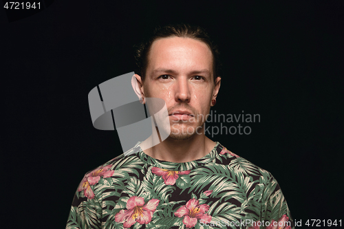 Image of Close up portrait of young man isolated on black studio background