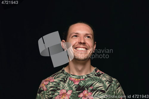 Image of Close up portrait of young man isolated on black studio background