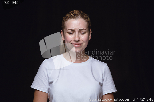 Image of Close up portrait of young woman isolated on black studio background