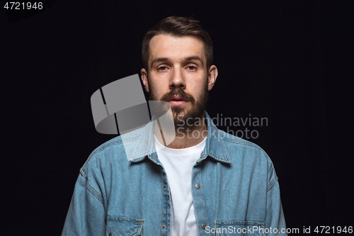 Image of Close up portrait of young man isolated on black studio background