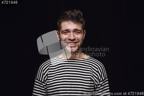 Image of Close up portrait of young man isolated on black studio background