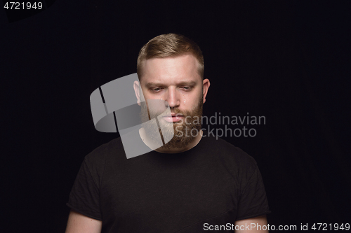 Image of Close up portrait of young man isolated on black studio background