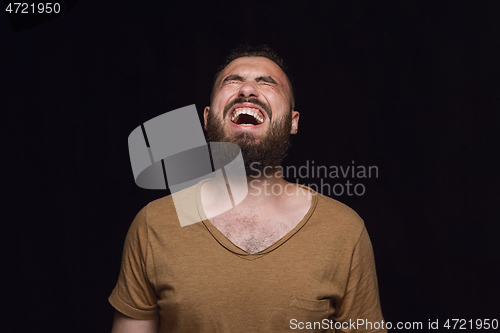 Image of Close up portrait of young man isolated on black studio background