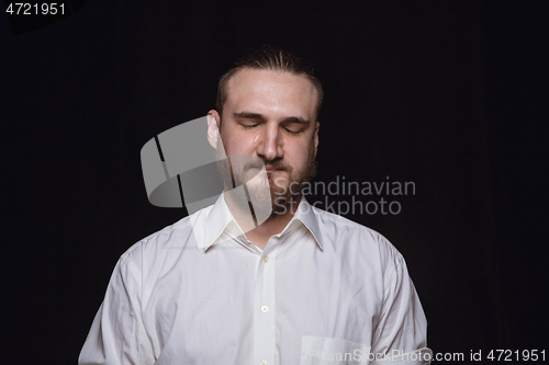 Image of Close up portrait of young man isolated on black studio background