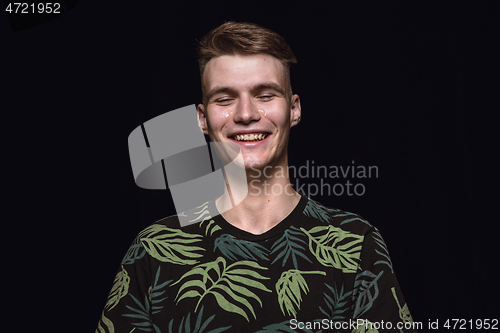 Image of Close up portrait of young man isolated on black studio background