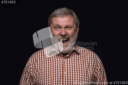 Image of Close up portrait of senior man isolated on black studio background