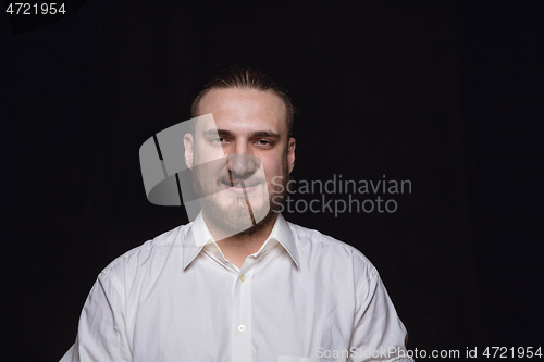 Image of Close up portrait of young man isolated on black studio background