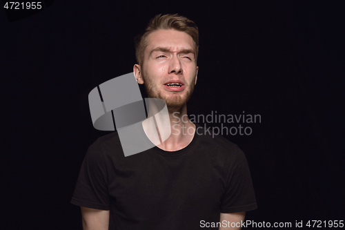 Image of Close up portrait of young man isolated on black studio background