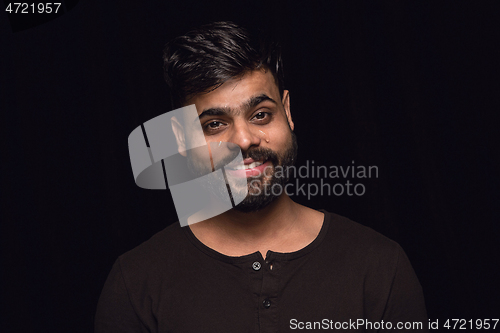 Image of Close up portrait of young man isolated on black studio background