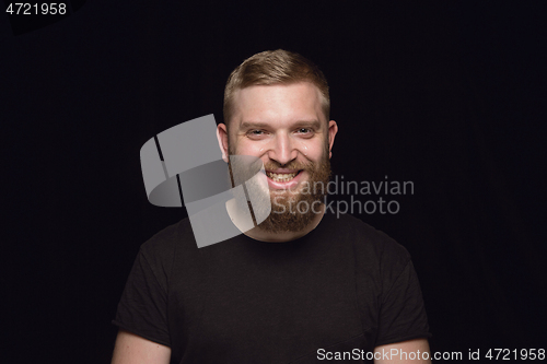 Image of Close up portrait of young man isolated on black studio background