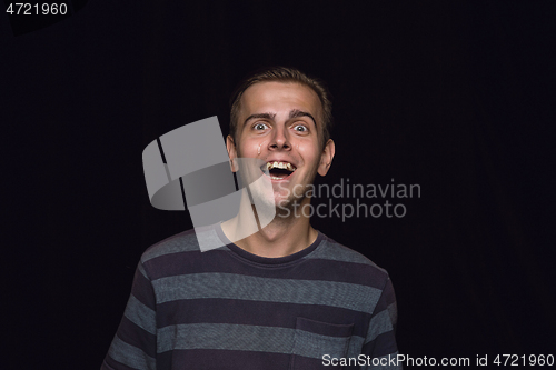 Image of Close up portrait of young man isolated on black studio background