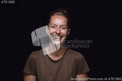 Image of Close up portrait of young woman isolated on black studio background