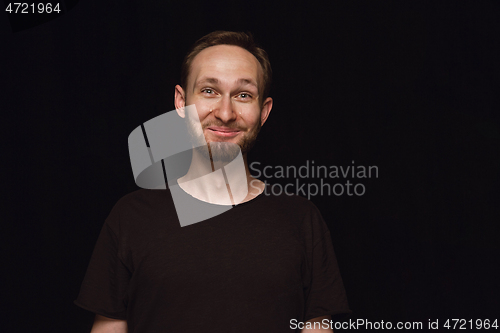 Image of Close up portrait of young man isolated on black studio background