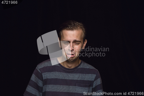 Image of Close up portrait of young man isolated on black studio background