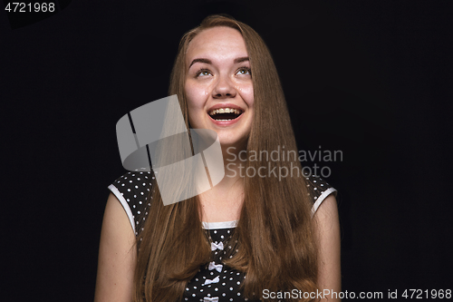 Image of Close up portrait of young woman isolated on black studio background