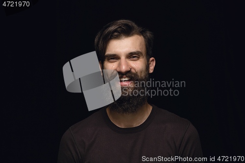 Image of Close up portrait of young man isolated on black studio background