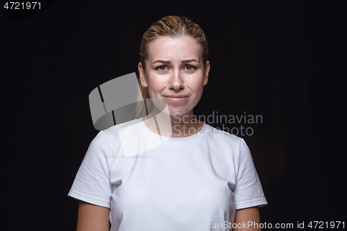 Image of Close up portrait of young woman isolated on black studio background