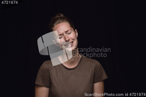 Image of Close up portrait of young woman isolated on black studio background