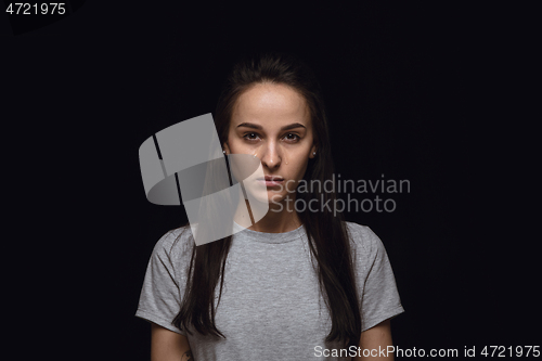 Image of Close up portrait of young woman isolated on black studio background